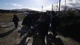 Bosnia moves migrants away from burnt-out camp
